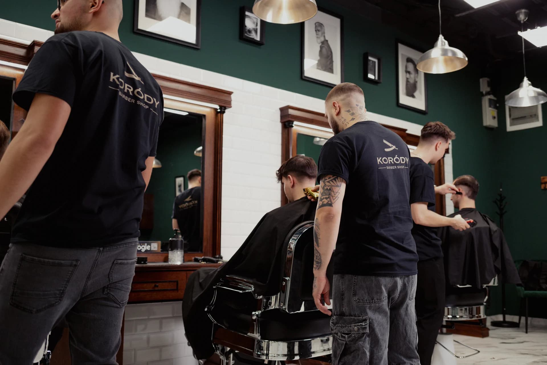Borbélyok munka közben a Koródy Barber Shop zöld falú szalonjában